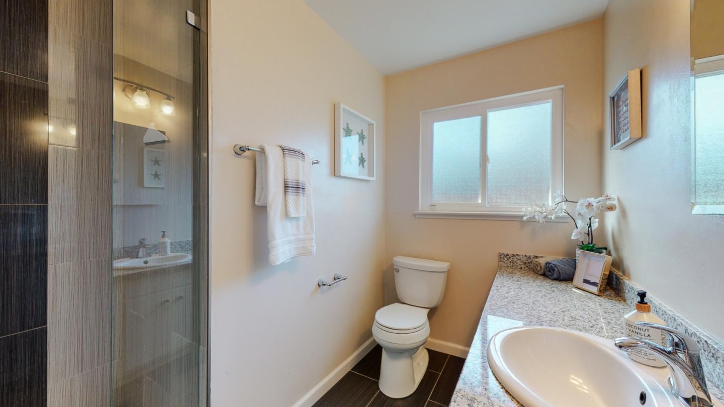 5378 Carter Avenue San Jose, CA 95118 - Photo 18 of 38 a bathroom with a granite countertop toilet sink and mirror