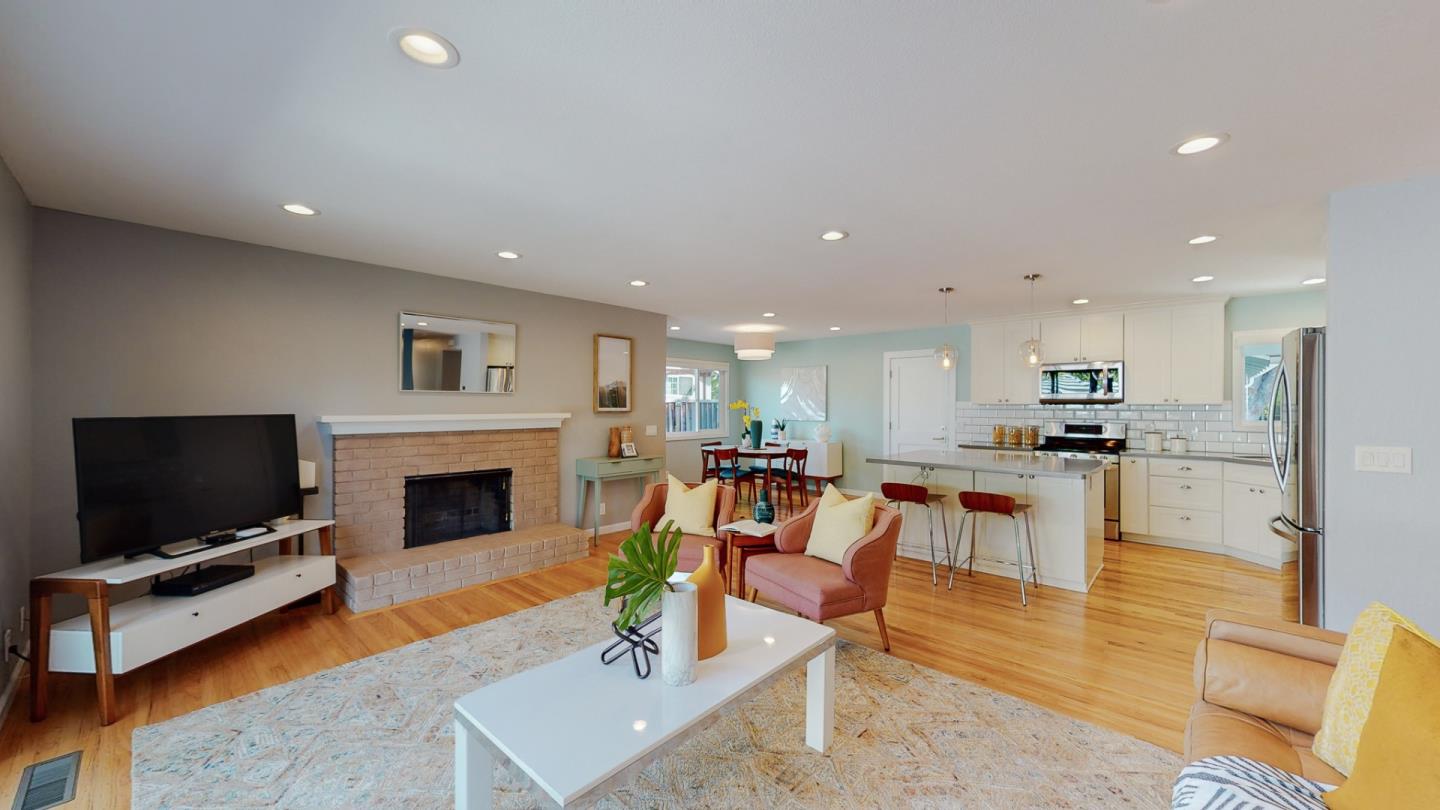5378 Carter Avenue San Jose, CA 95118 - Photo 5 of 38 a living room with furniture a flat screen tv and a fireplace