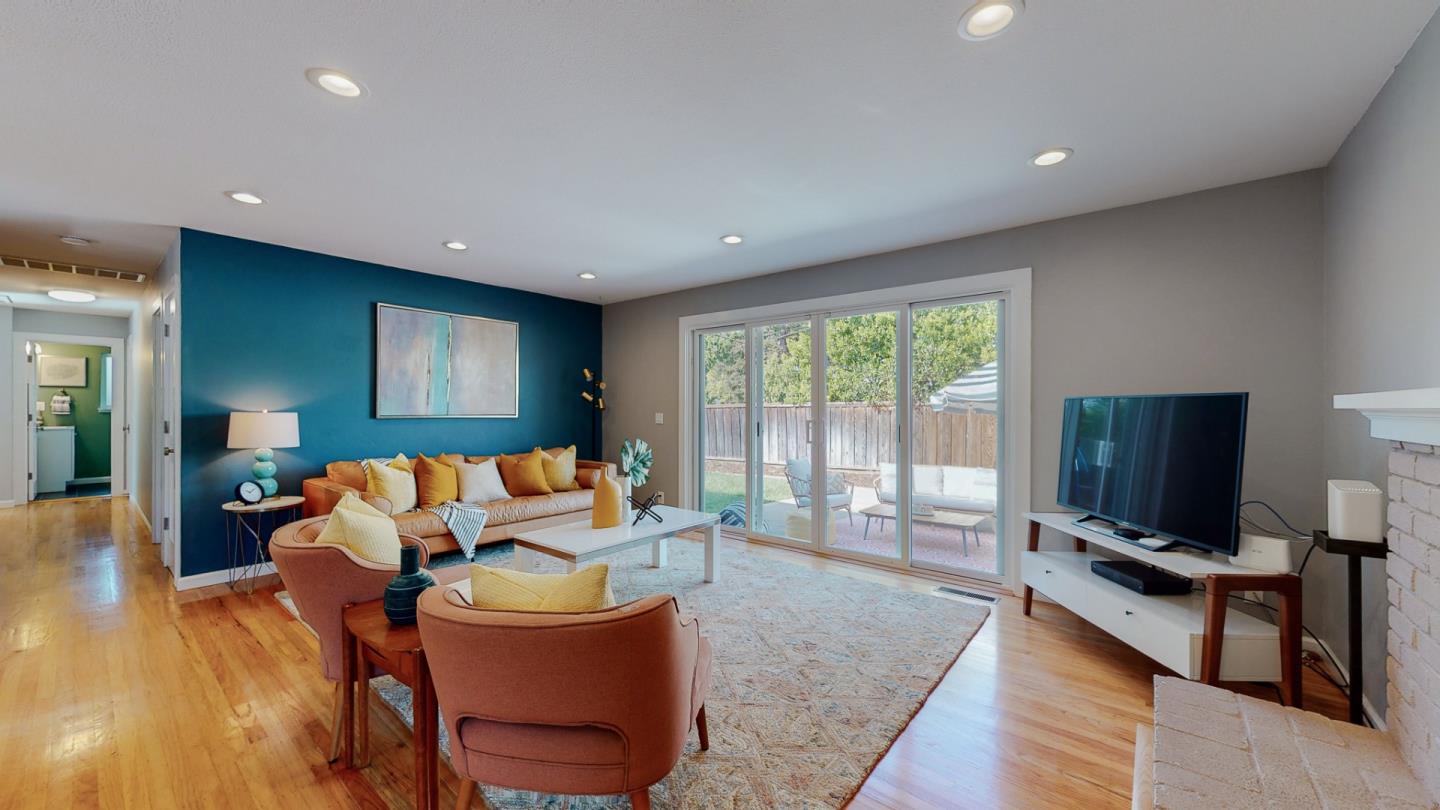 5378 Carter Avenue San Jose, CA 95118 - Photo 7 of 38 a living room with furniture a flat screen tv and a floor to ceiling window