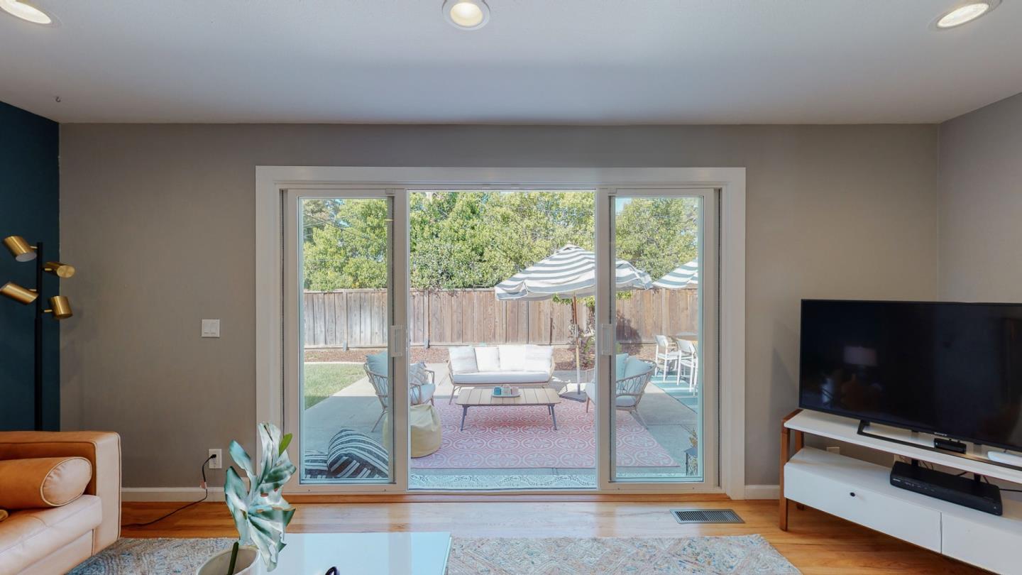 5378 Carter Avenue San Jose, CA 95118 - Photo 8 of 38 a living room with furniture a flat screen tv and floor to ceiling window