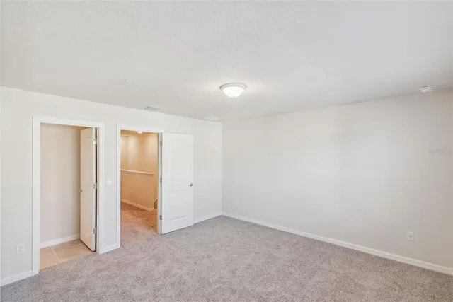 an empty room with closet area