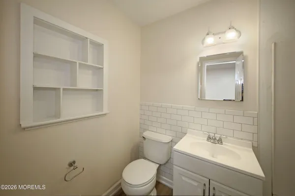 a bathroom with a sink mirror and toilet