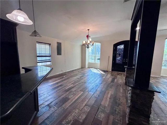 a view of a hallway with wooden floor and stairs