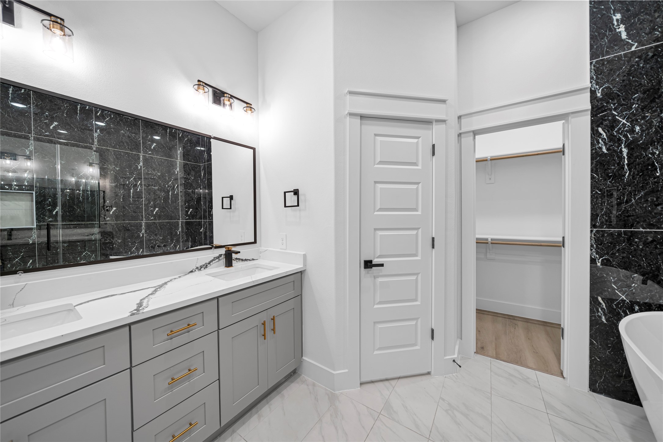 4834 Higgins Street, Unit B Houston, TX 77033 - Photo 16 of 34 a spacious bathroom with a shower sink and mirror