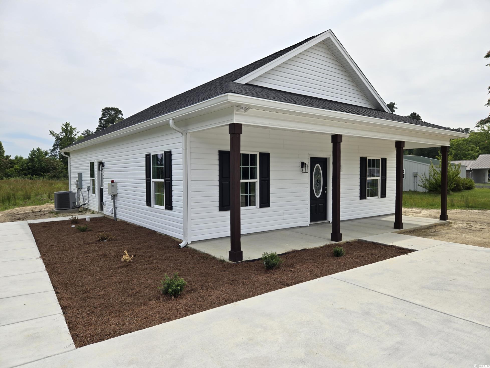 View of front of property with a porch and a shingled roof