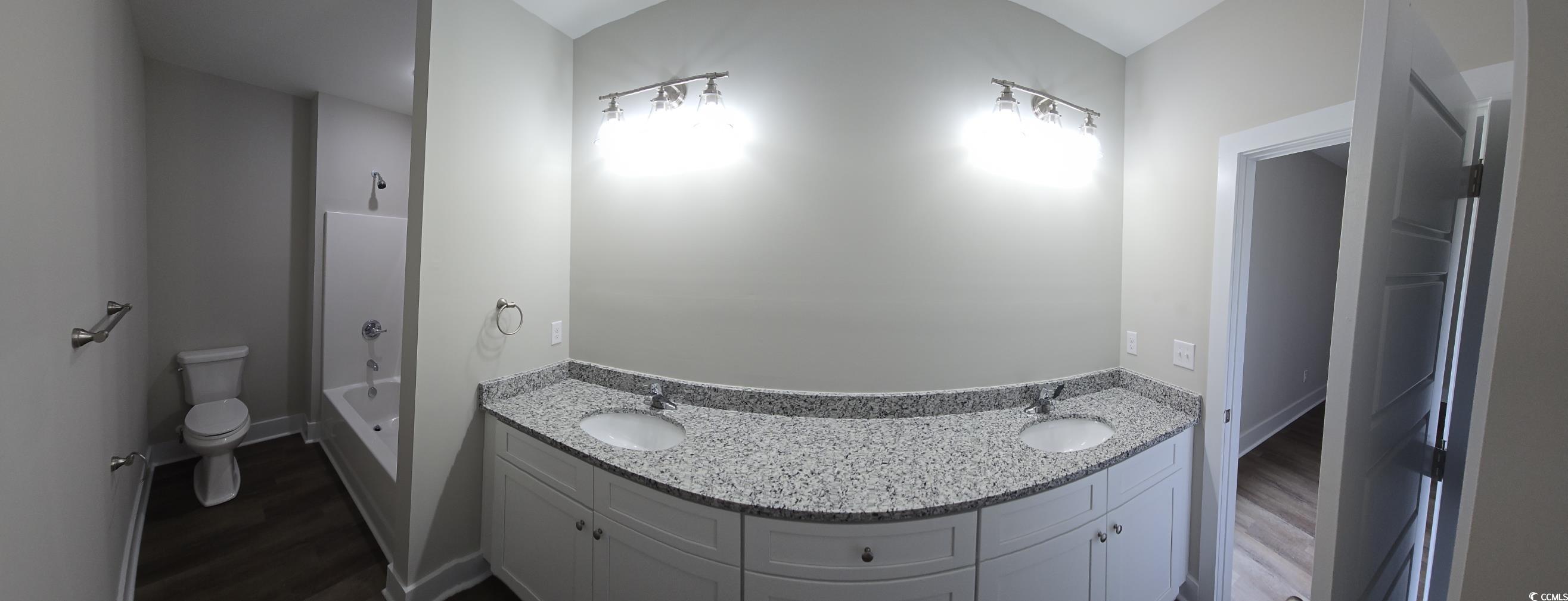 4890 Highway 319 Aynor, SC 29511 - Photo 16 of 21 Full bath with dark wood-style flooring, double vanity, and shower / tub combination