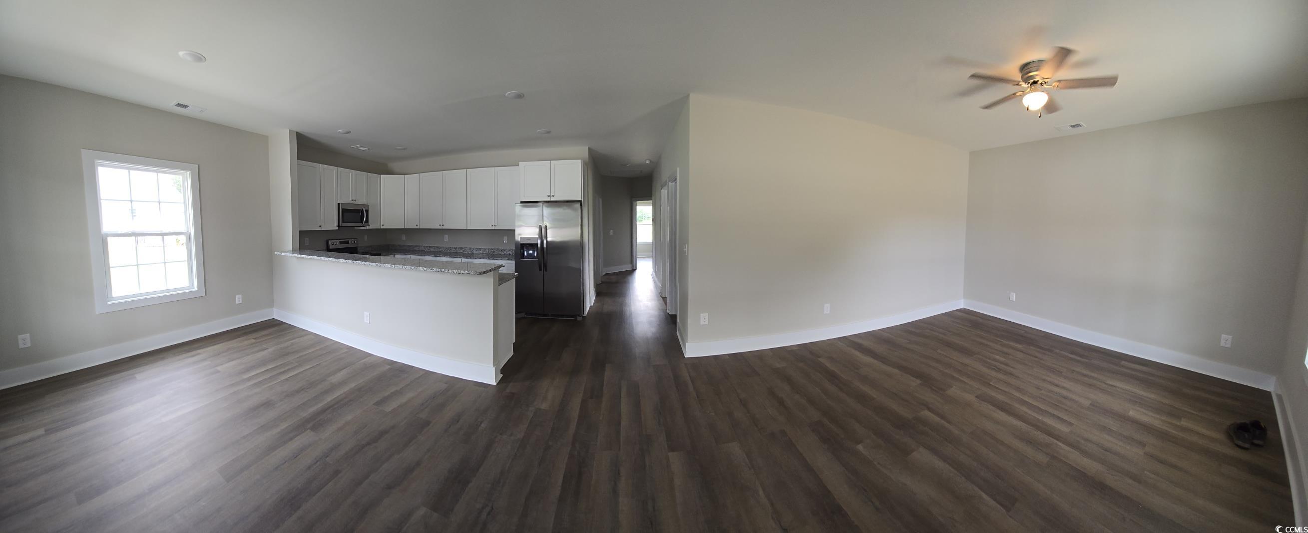 4890 Highway 319 Aynor, SC 29511 - Photo 21 of 21 Kitchen with open floor plan, white cabinetry, a peninsula, and dark wood-type flooring