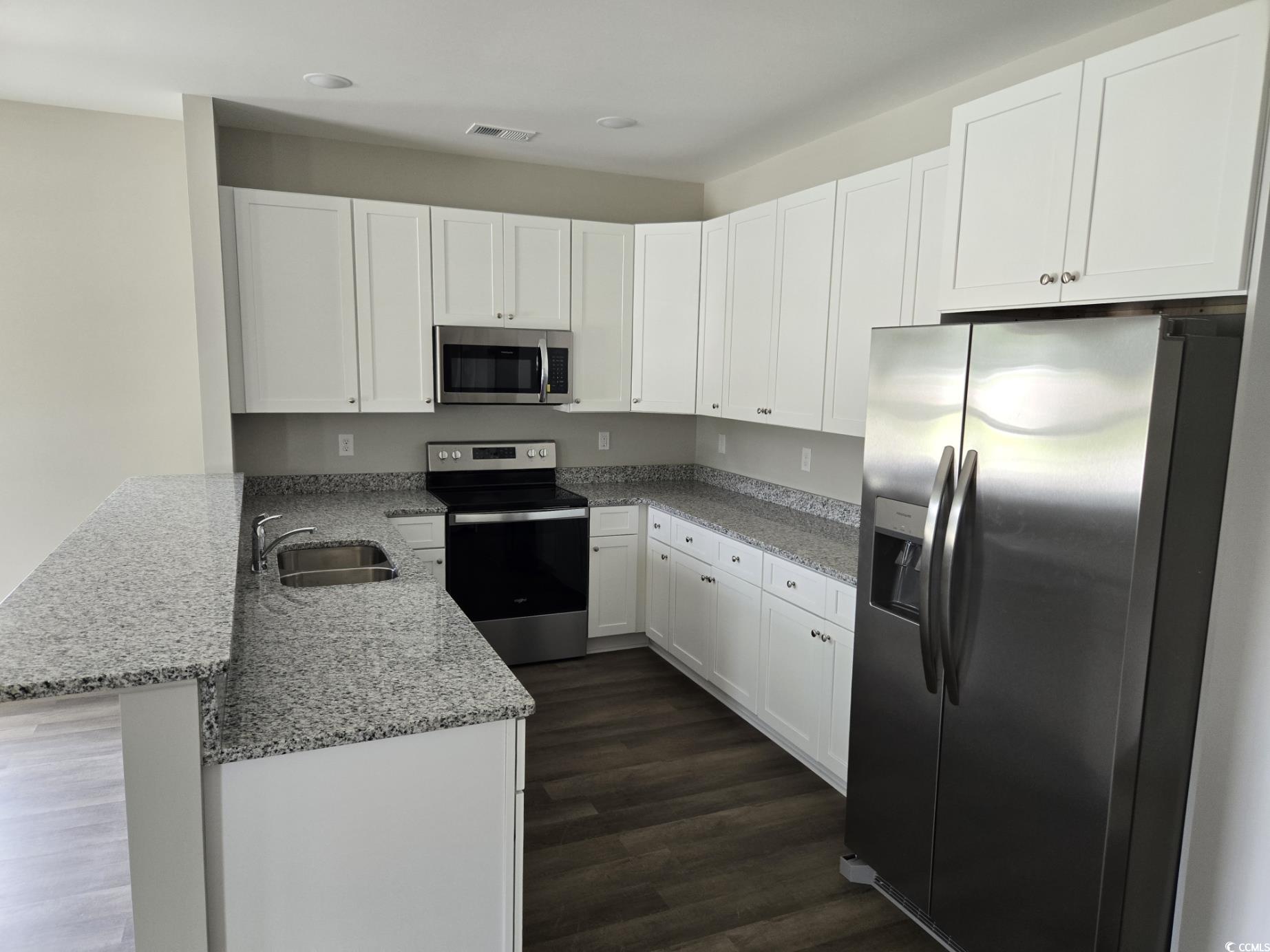 4890 Highway 319 Aynor, SC 29511 - Photo 6 of 21 Kitchen featuring appliances with stainless steel finishes, light stone counters, and white cabinetry