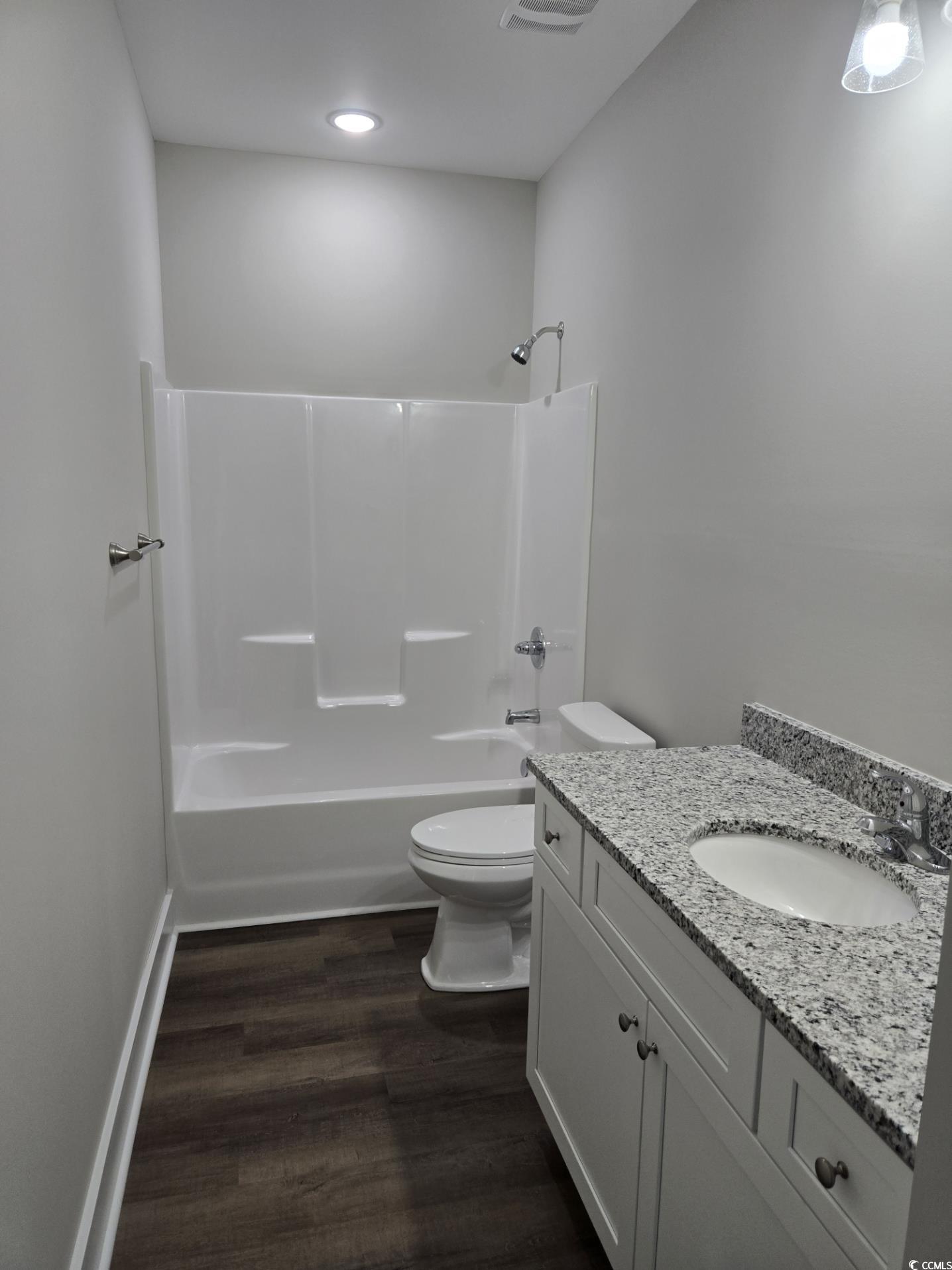 4890 Highway 319 Aynor, SC 29511 - Photo 7 of 21 Bathroom featuring dark wood-style floors, washtub / shower combination, and vanity