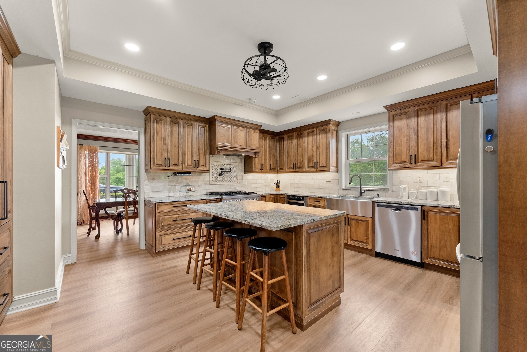 7215 Kelly Bridge Road Dawsonville, GA 30534 - Photo 7 of 81 a kitchen with stainless steel appliances granite countertop wooden floors and white cabinets