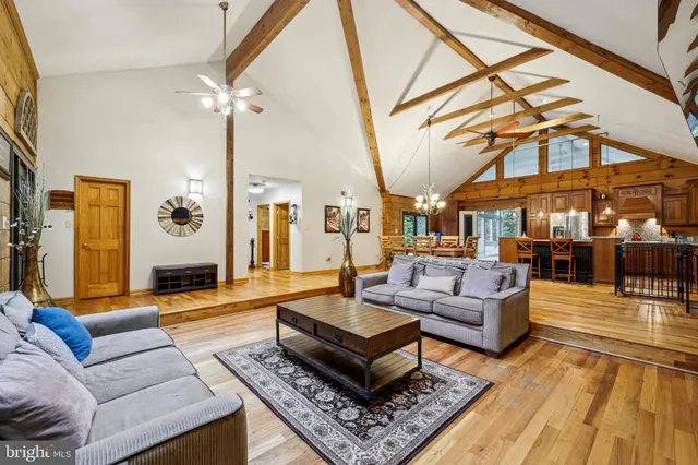 a living room with furniture a rug and a chandelier