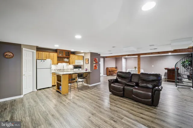 a living room with furniture and view of kitchen