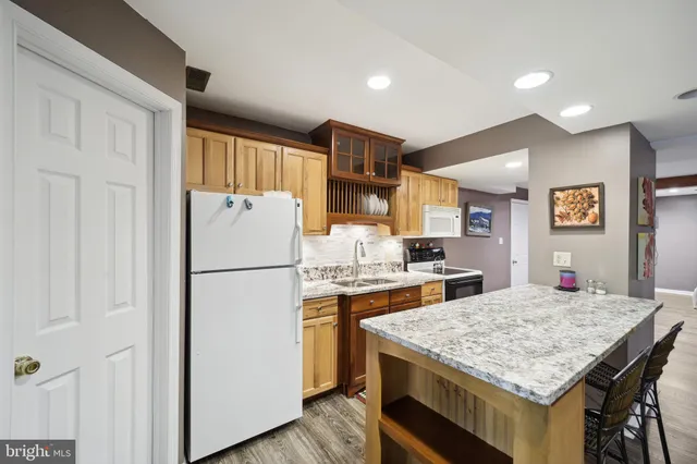 a kitchen with a stove a refrigerator and a table
