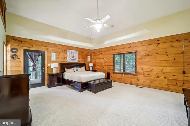 a spacious bedroom with a bed and window