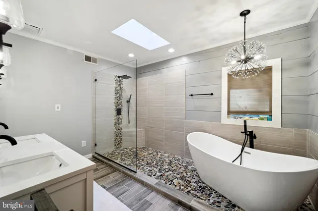 a bathroom with a bathtub and shower