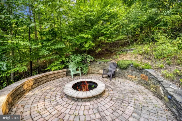 a view of swimming pool with outdoor seating and plants