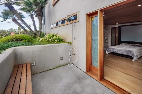 an aerial view of a house with balcony and garden