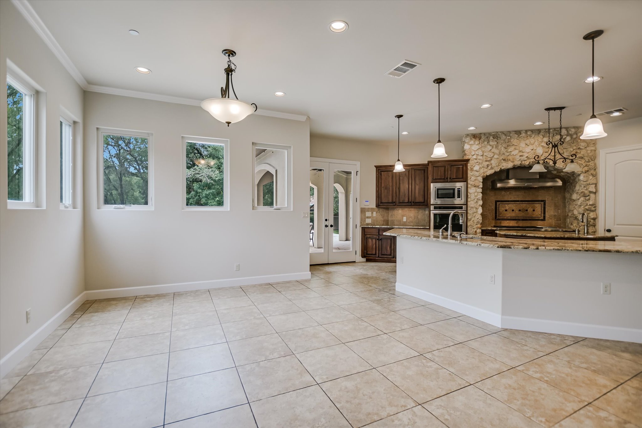 11 Inwood Circle Austin, TX 78746 - Photo 13 of 38 An open-concept living area boasts a generously sized kitchen island and seamless flow to the dining space.