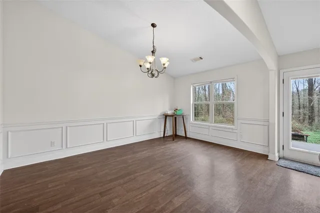 a bedroom with a bed and a flat tv screen on a table