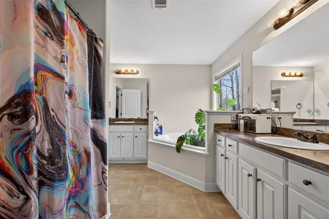 a bedroom with furniture and a flat screen tv