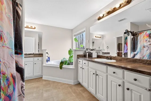 a bedroom with a bed a window and a flat screen tv