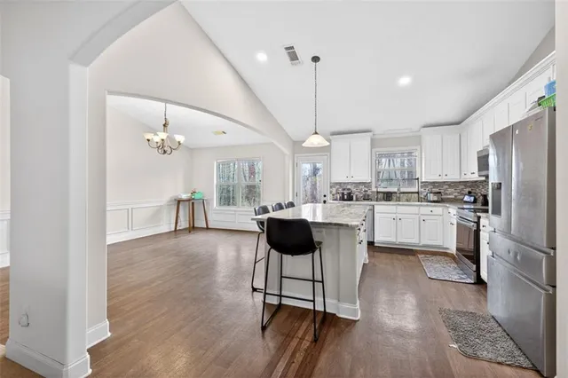 a kitchen with a kitchen island a stove and a wooden floor