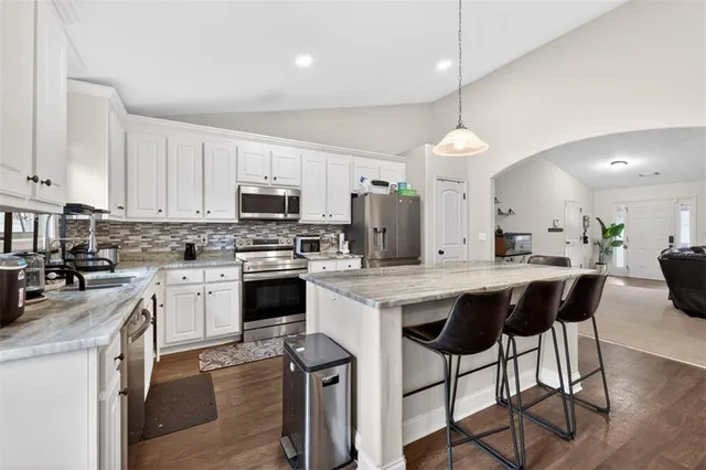 a view of a livingroom with wooden floor and a window