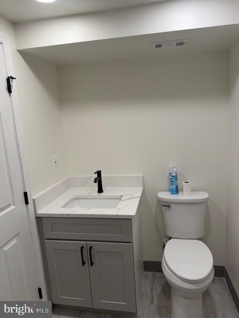 1104 Eastbourne Place Silver Spring, MD 20904 - Photo 6 of 12 a bathroom with a toilet sink and mirror