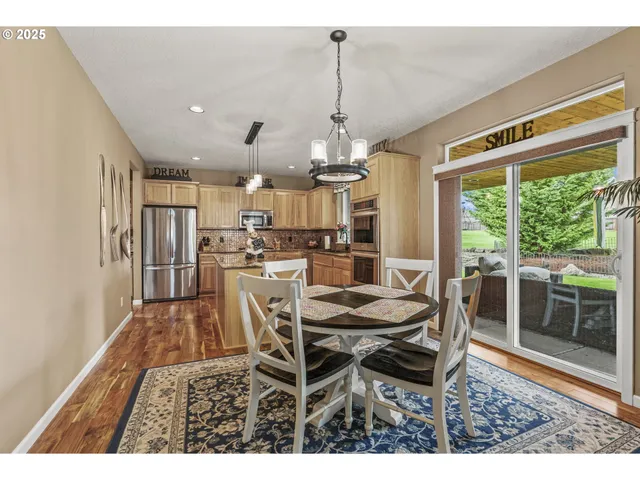 a dining room with furniture and a floor to ceiling window
