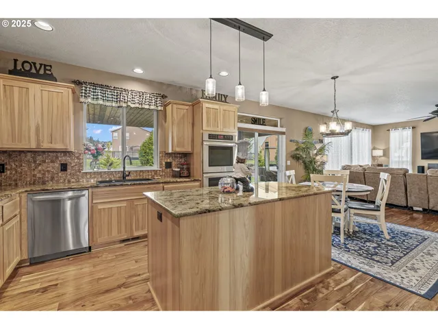 a kitchen with stainless steel appliances granite countertop a sink and cabinets