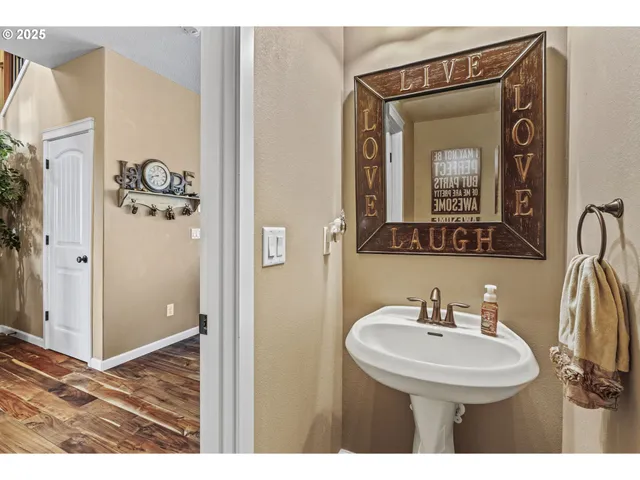 a view of entryway with an empty room and wooden floor