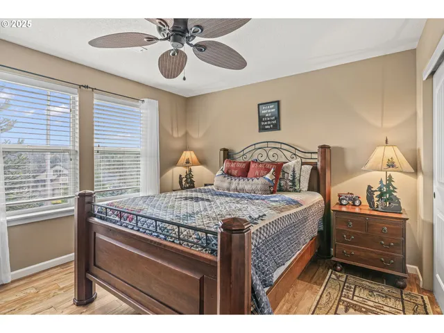 a view of a hallway with wooden floor and a clock on wall