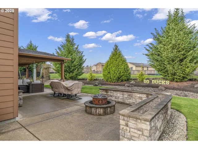 a front view of house with yard barbeque and outdoor seating