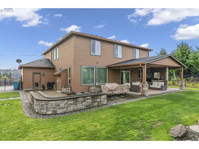 a view of a house with backyard porch and sitting area