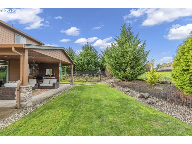 a view of a yard in front of a house with a fountain