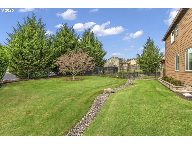 an aerial view of a house with a garden and trees