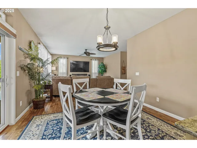 a dining room with furniture a chandelier and window