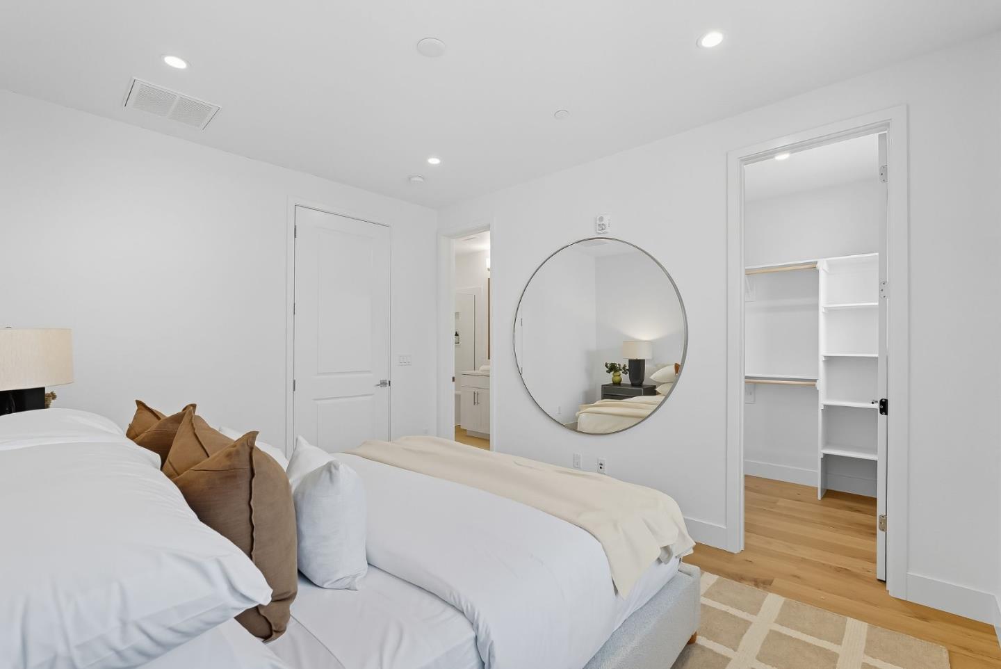 1387 West Middlefield Road Mountain View, CA 94043 - Photo 17 of 28 a spacious bedroom with a bed a mirror and a table