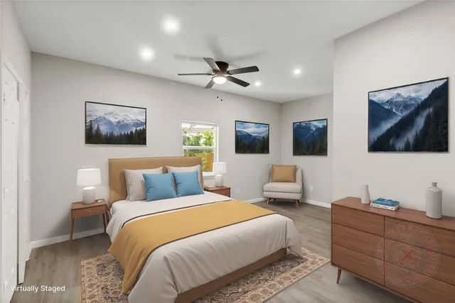 a bedroom with furniture and a flat screen tv