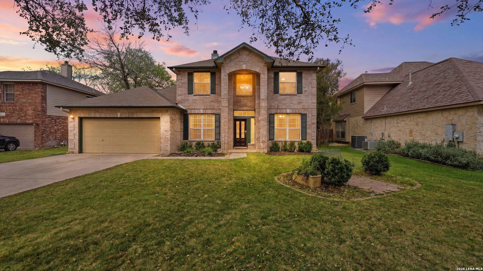 a front view of a house with a yard and garage