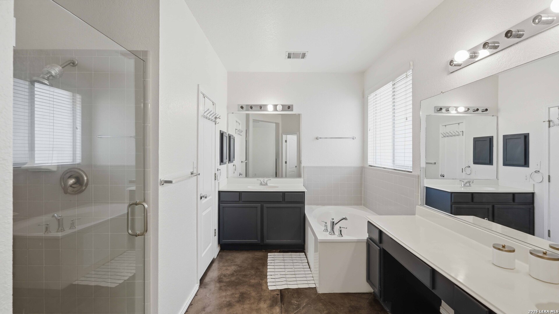4520 Ridge Peak Drive Schertz, TX 78154 - Photo 16 of 44 a bathroom with a double vanity sink toilet mirror and bathtub