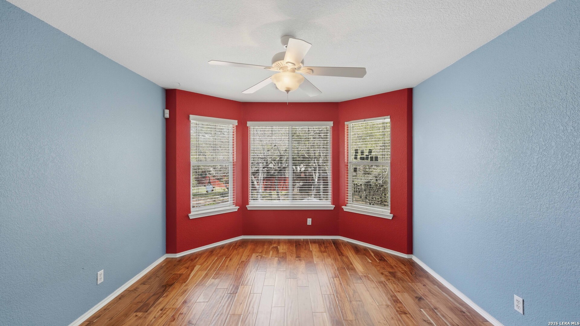 4520 Ridge Peak Drive Schertz, TX 78154 - Photo 26 of 44 a view of an empty room with wooden floor and a window