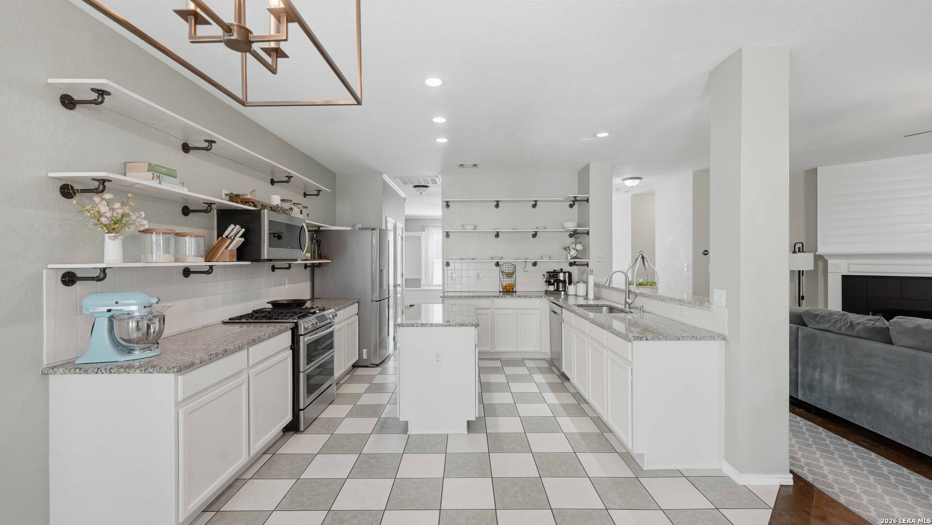 4520 Ridge Peak Drive Schertz, TX 78154 - Photo 3 of 44 a large white kitchen with stainless steel appliances and white cabinets