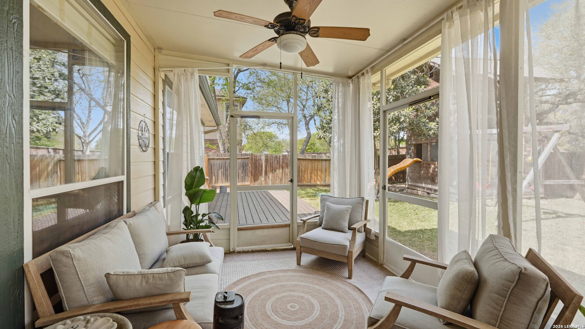 4520 Ridge Peak Drive Schertz, TX 78154 - Photo 31 of 44 a living room with furniture and a floor to ceiling window