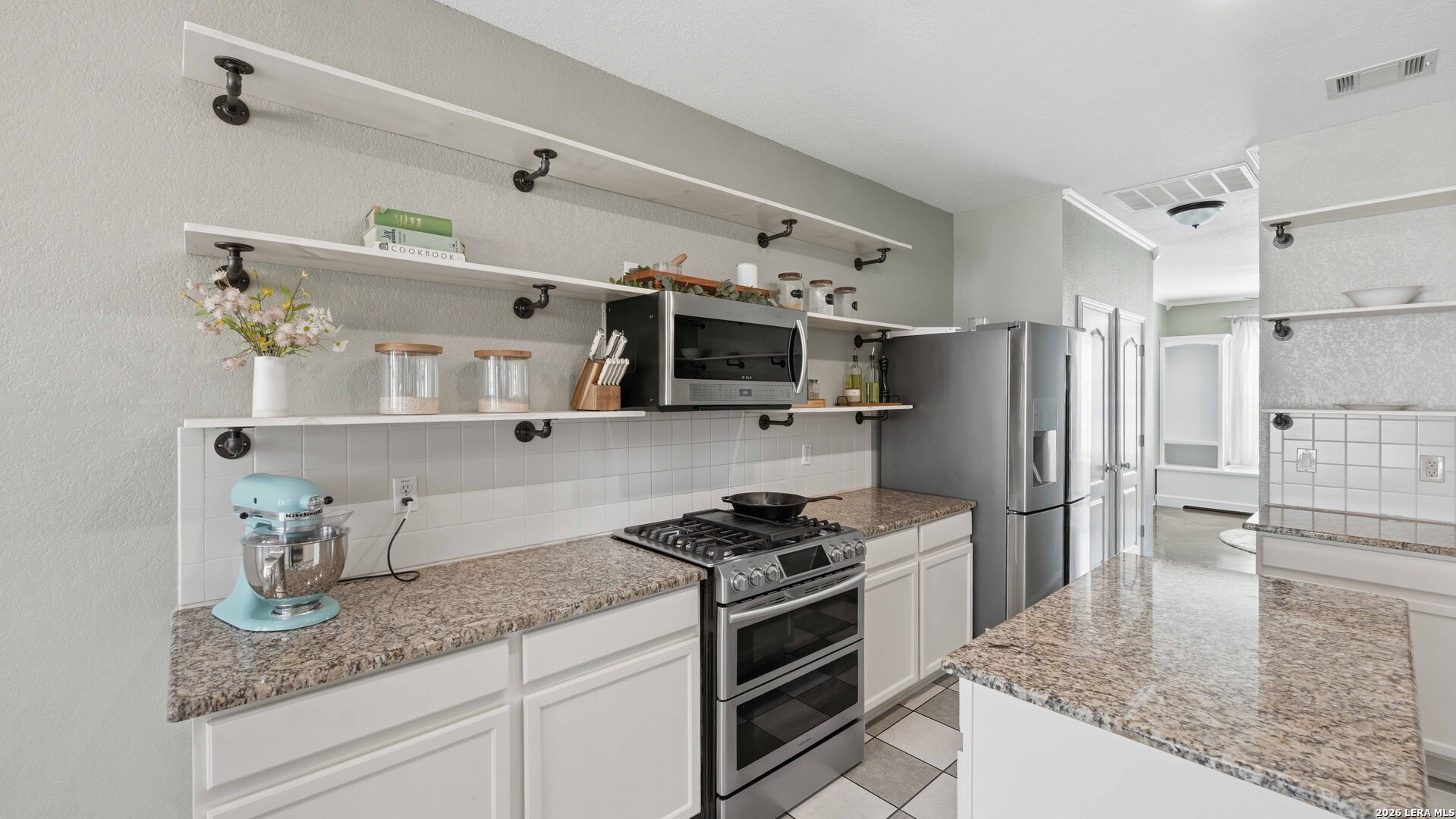 4520 Ridge Peak Drive Schertz, TX 78154 - Photo 4 of 44 a kitchen with stainless steel appliances granite countertop a sink stove and refrigerator