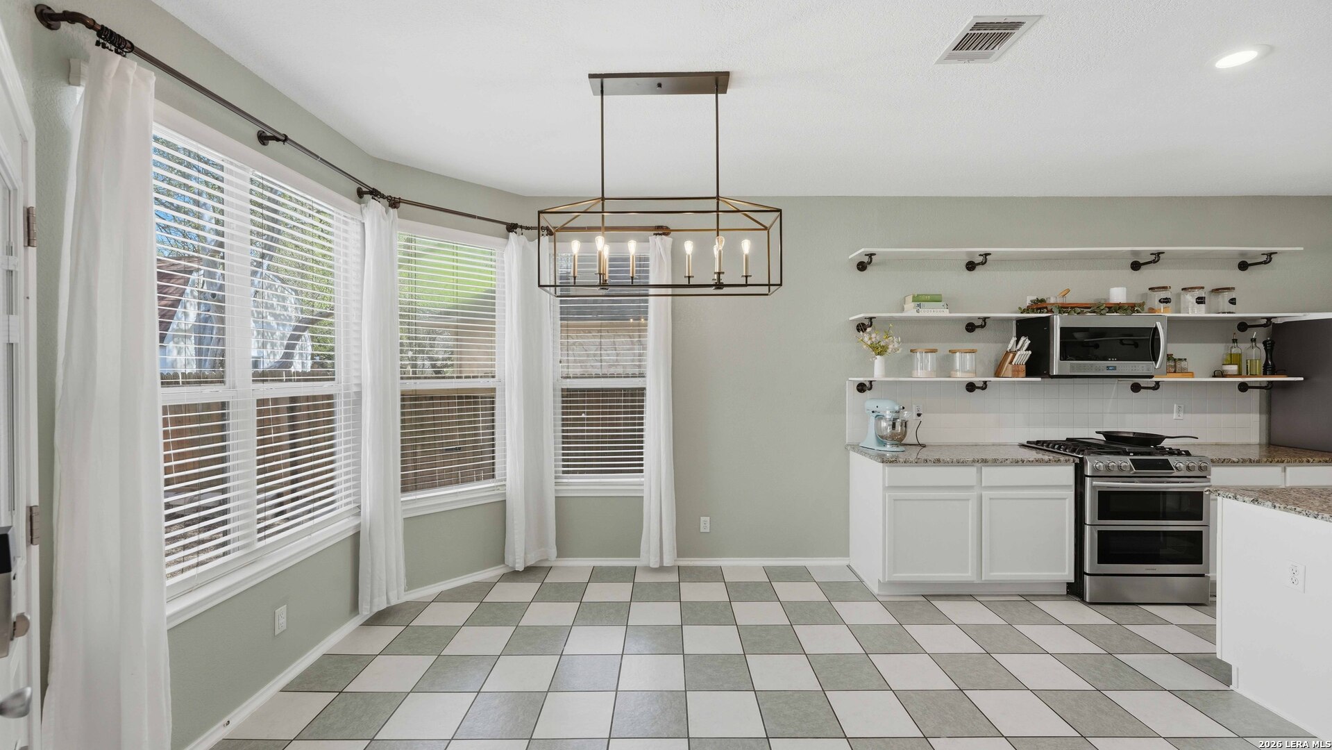 4520 Ridge Peak Drive Schertz, TX 78154 - Photo 6 of 44 a kitchen with stainless steel appliances granite countertop a stove a sink and a refrigerator