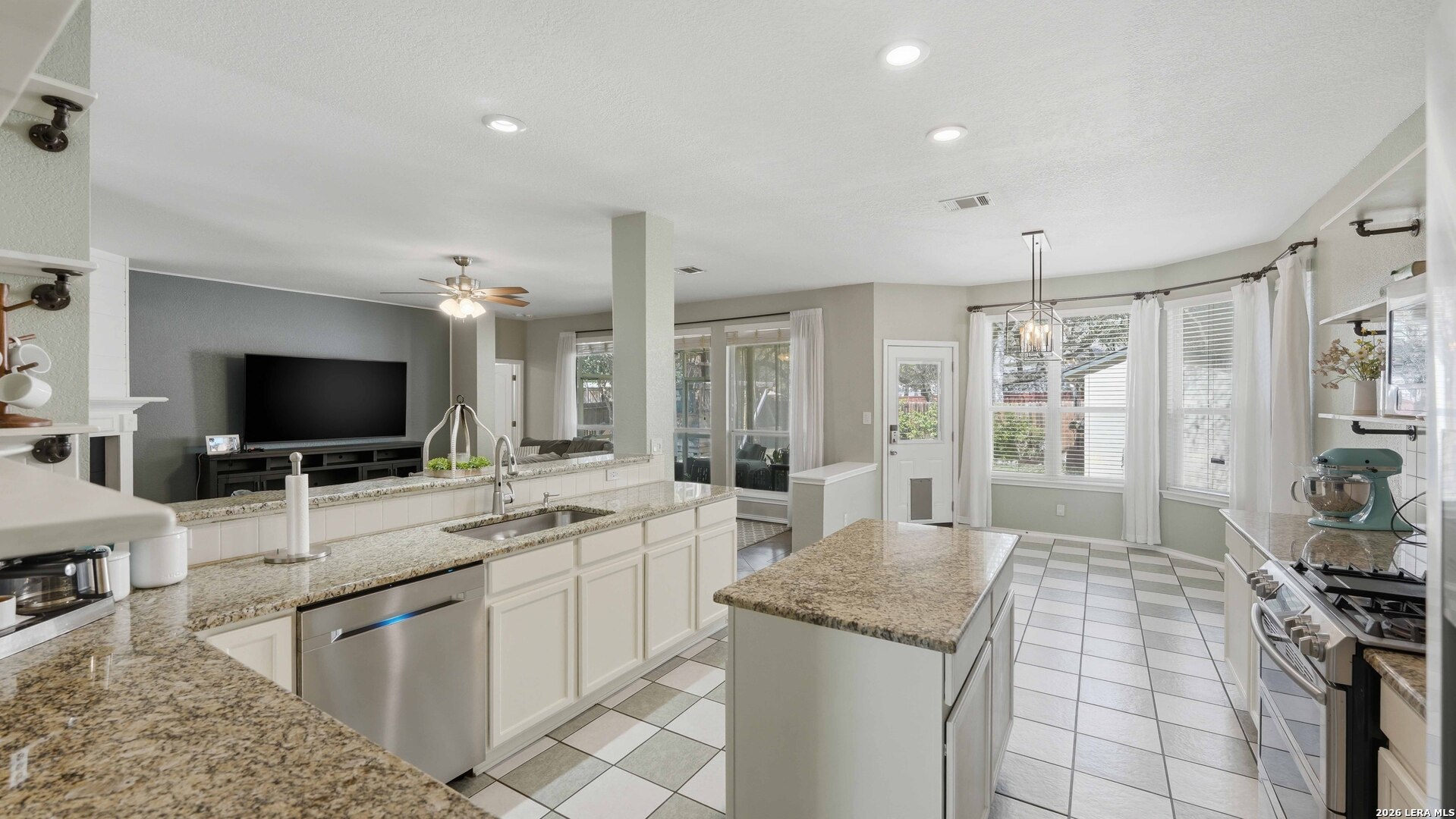 4520 Ridge Peak Drive Schertz, TX 78154 - Photo 8 of 44 a large white kitchen with a large window and stainless steel appliances