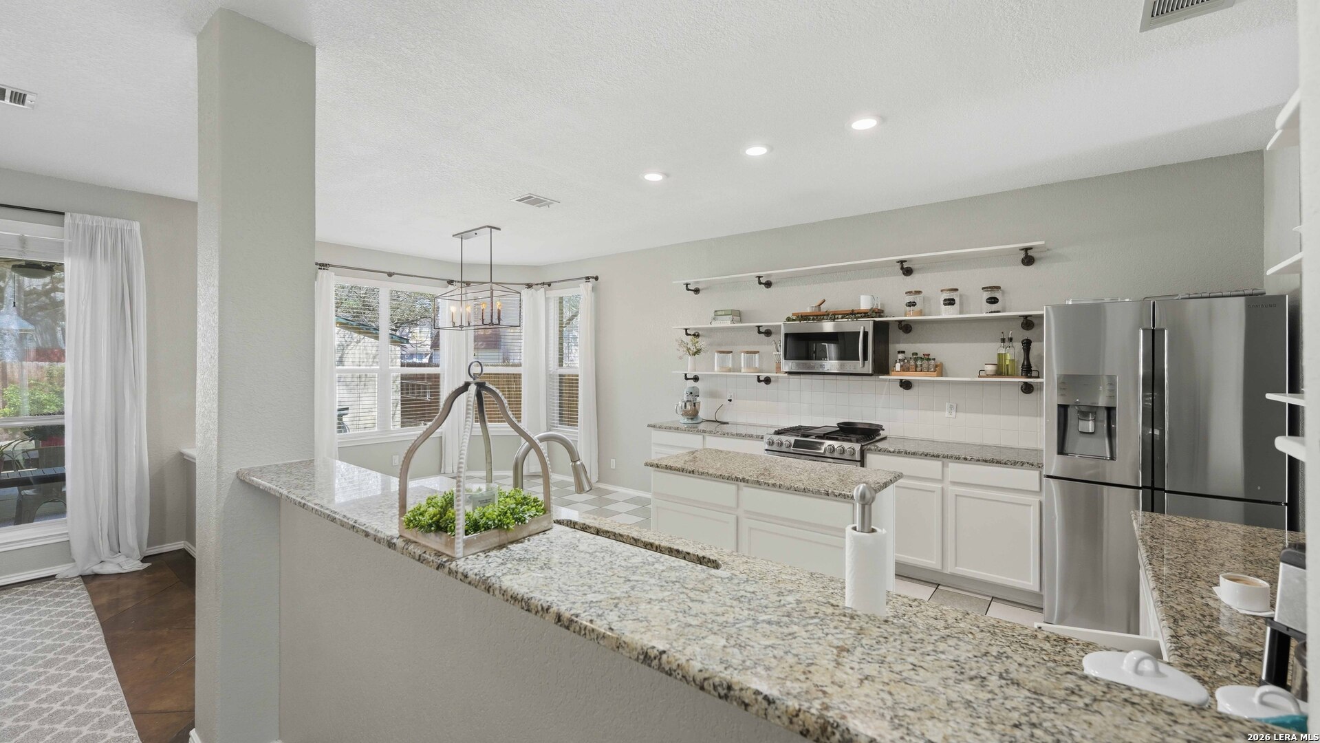 4520 Ridge Peak Drive Schertz, TX 78154 - Photo 9 of 44 a kitchen with stainless steel appliances granite countertop a sink a stove and a refrigerator