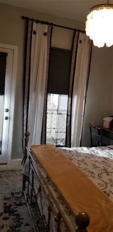 a bed sitting in a bedroom next to a window