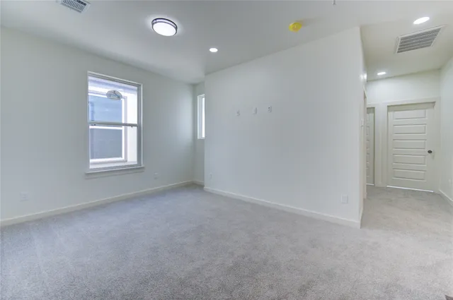an empty room with windows and closet